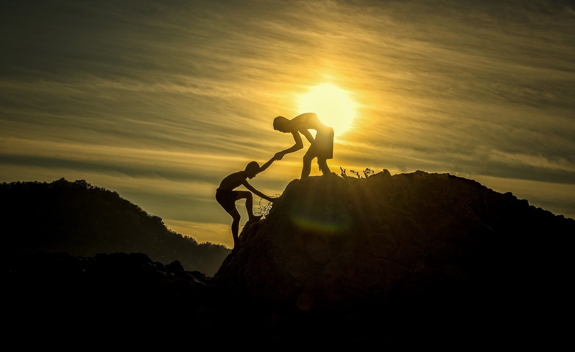 How to gain strength and willpower. Habits of a happy brain. two boys climbing a mountain, one helping the other.
