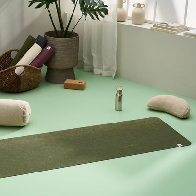 Lifestyle image of jute yoga mat, meditation cushion, yoga bolster, yoga blocks in a stylish modern home yoga studio #4mm-yoga-mat-colour_forest-green