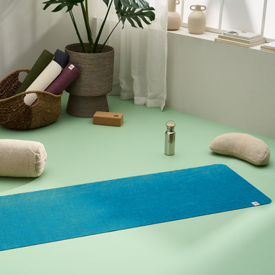 Lifestyle image of jute yoga mat, meditation cushion, yoga bolster, yoga blocks in a stylish modern home yoga studio #4mm-yoga-mat-colour_new-ocean-teal-blue