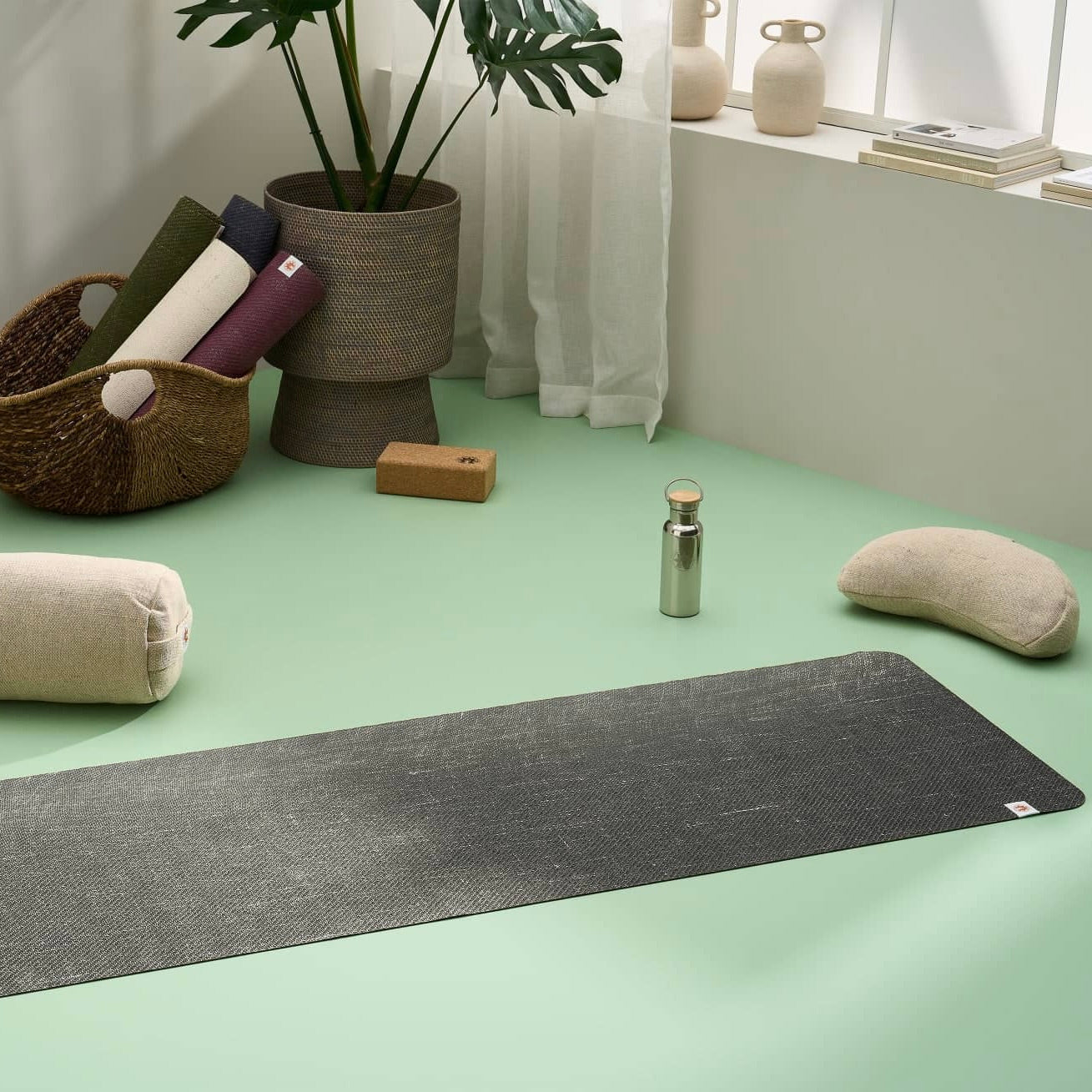 Lifestyle image of jute yoga mat, meditation cushion, yoga bolster, yoga blocks in a stylish modern home yoga studio #4mm-yoga-mat-colour_new-space-black